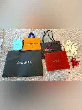 Designer shopping bags and ribbon Chanel, Louis Vuitton, Tiffany, Cartier. .